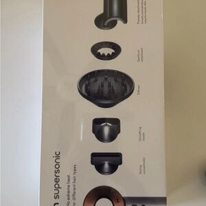 Dyson hair dryer attachment set in black and copper